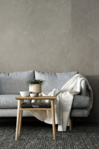 couch with blanket draped over it