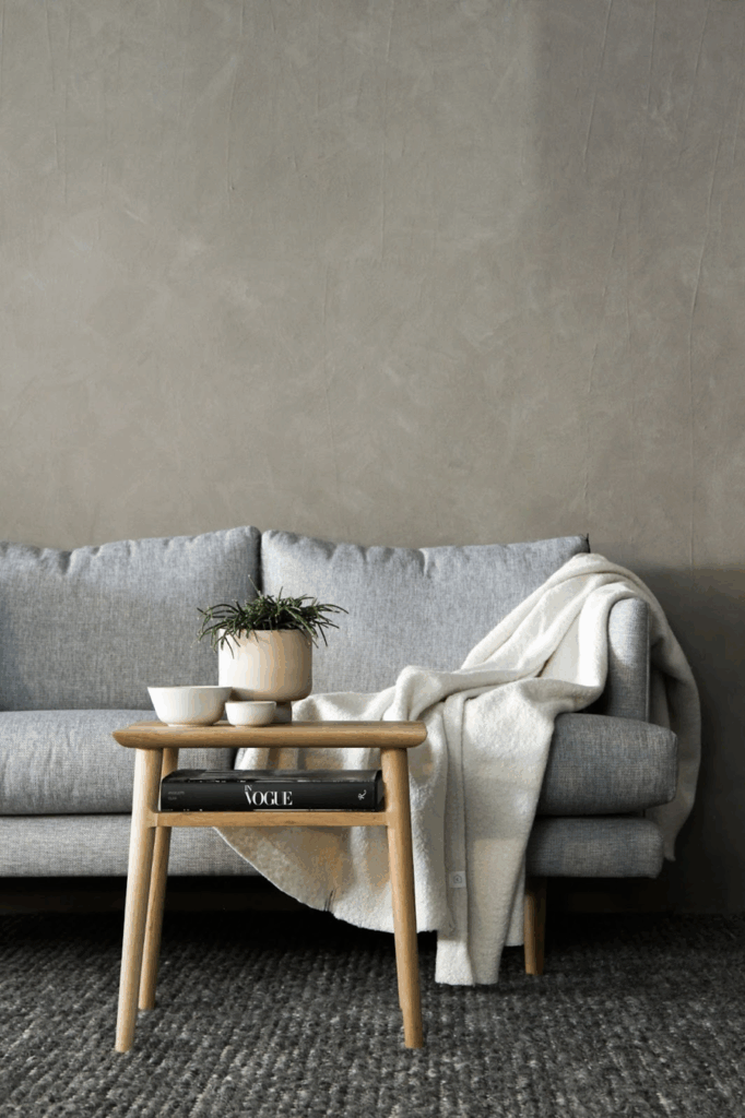 couch with blanket draped over it