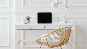 gold chair in front of desk with laptop