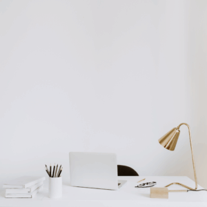 laptop and lamp sitting on desk