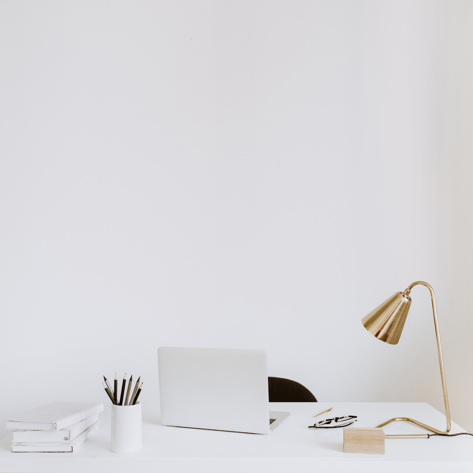 laptop and lamp sitting on desk