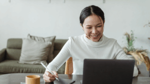 woman smiling while working at laptop