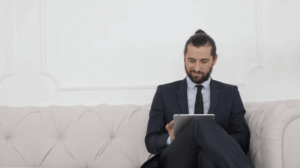 man reading about how to find a good real estate agent