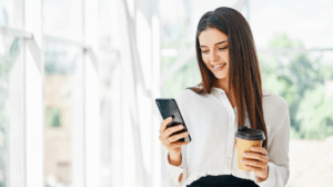 young woman smiling while using cell phone