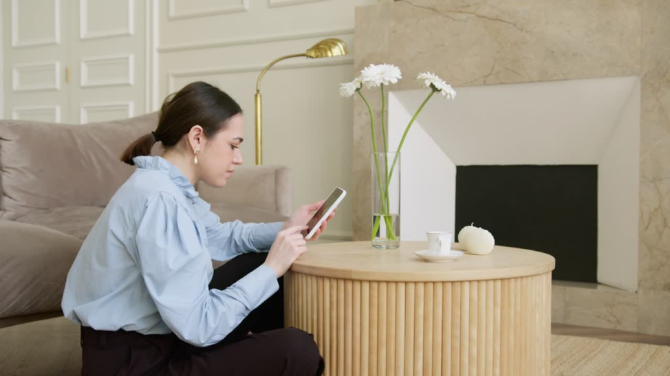 woman learning video editing tips on her smartphone